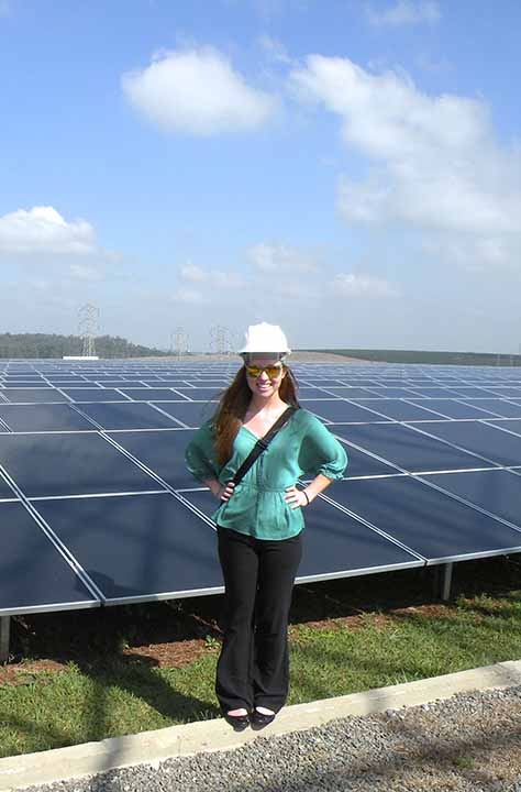 student on building top with solar panels