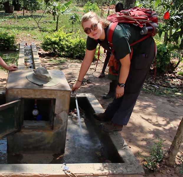 student working on water system as part of Engineers Without Borders project.