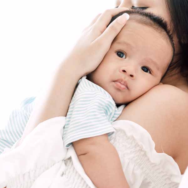 mother holding baby