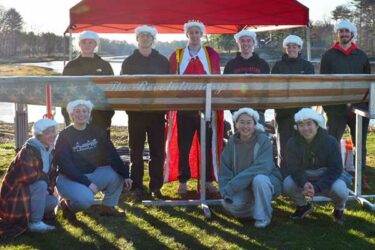 student team in group with concrete canoe at competition