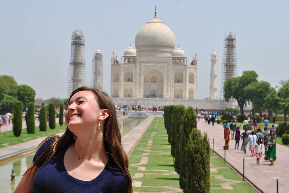 student in India with building in back