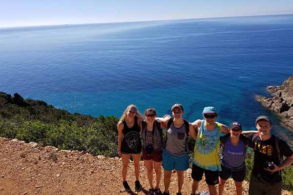 Students in Italy in front of view of water